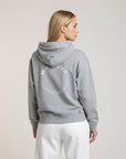 Women's premium heavyweight hoodie in ash heather with "Confidence Worn" text, back view.