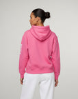 Women's premium heavyweight hoodie in pink, back view.