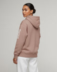 Women's premium heavyweight hoodie in taupe with "WHATEVR" text, side view.